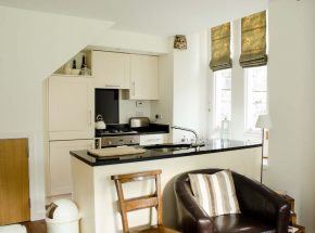 The kitchen area with black granite worktop