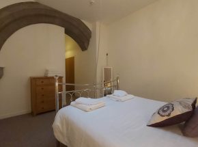Master bedroom - original chapel sandstone features