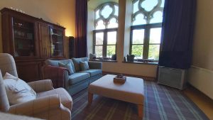 Lochside Library spacious living room with magnificent view through the original library windows