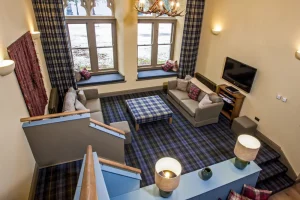 Caladh mezzanine bedroom looks onto the spacious yet cosy furnishings of the living area
